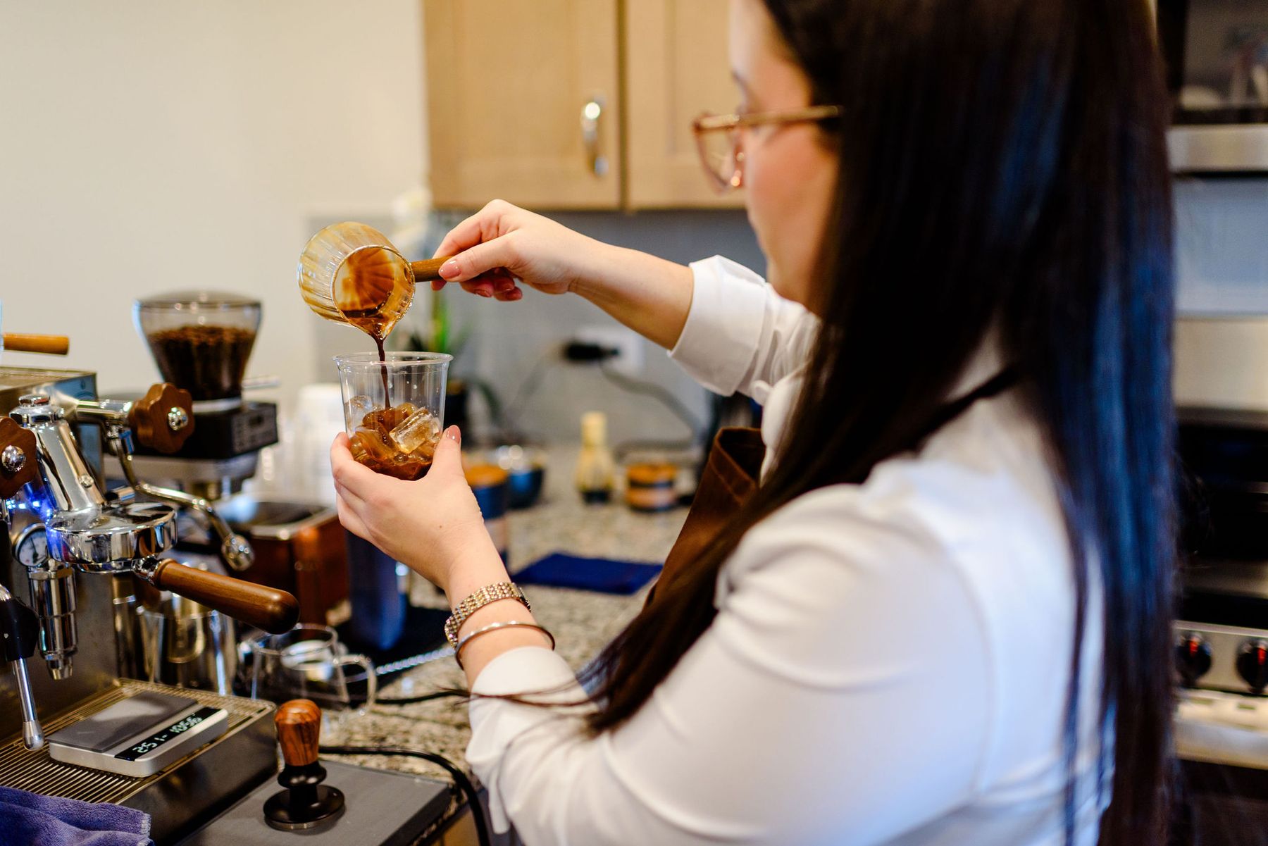 Pouring a fresh espresso over ice