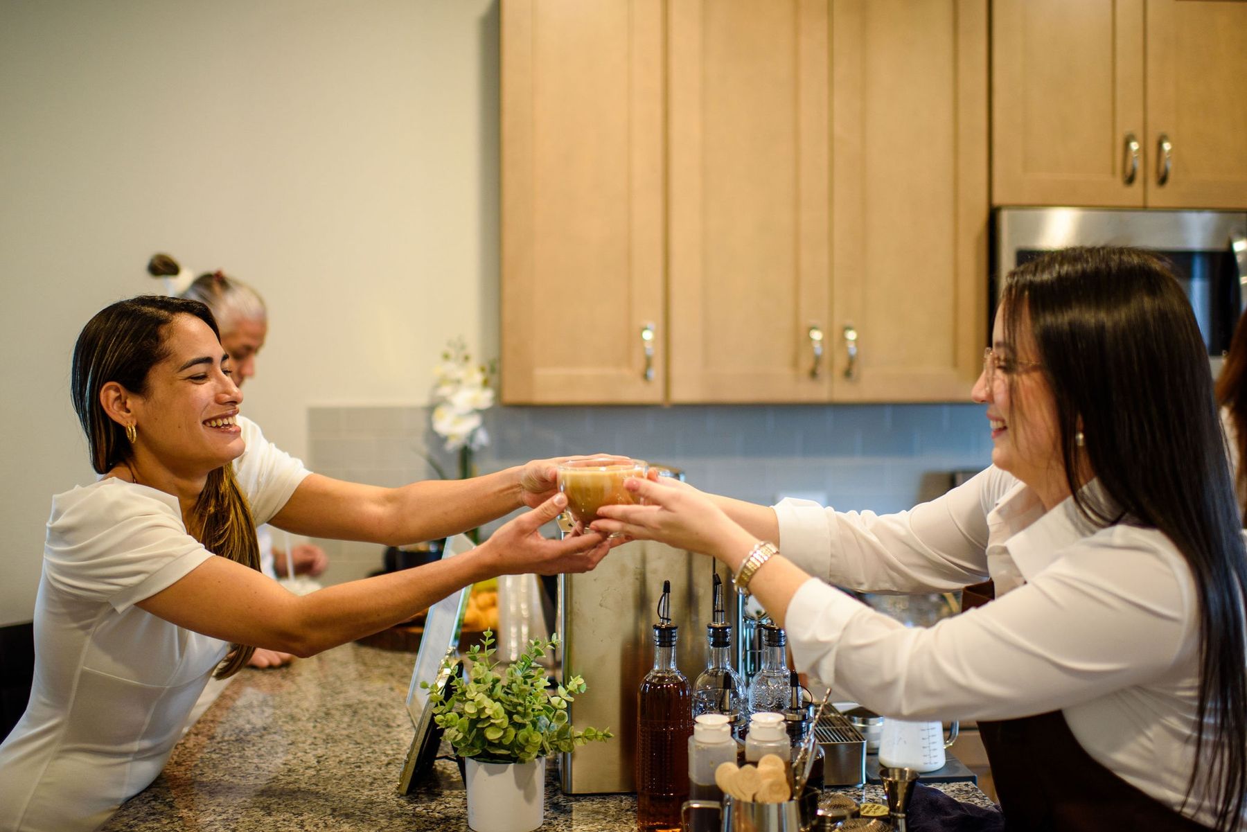 Handing a latte to a smiling guest