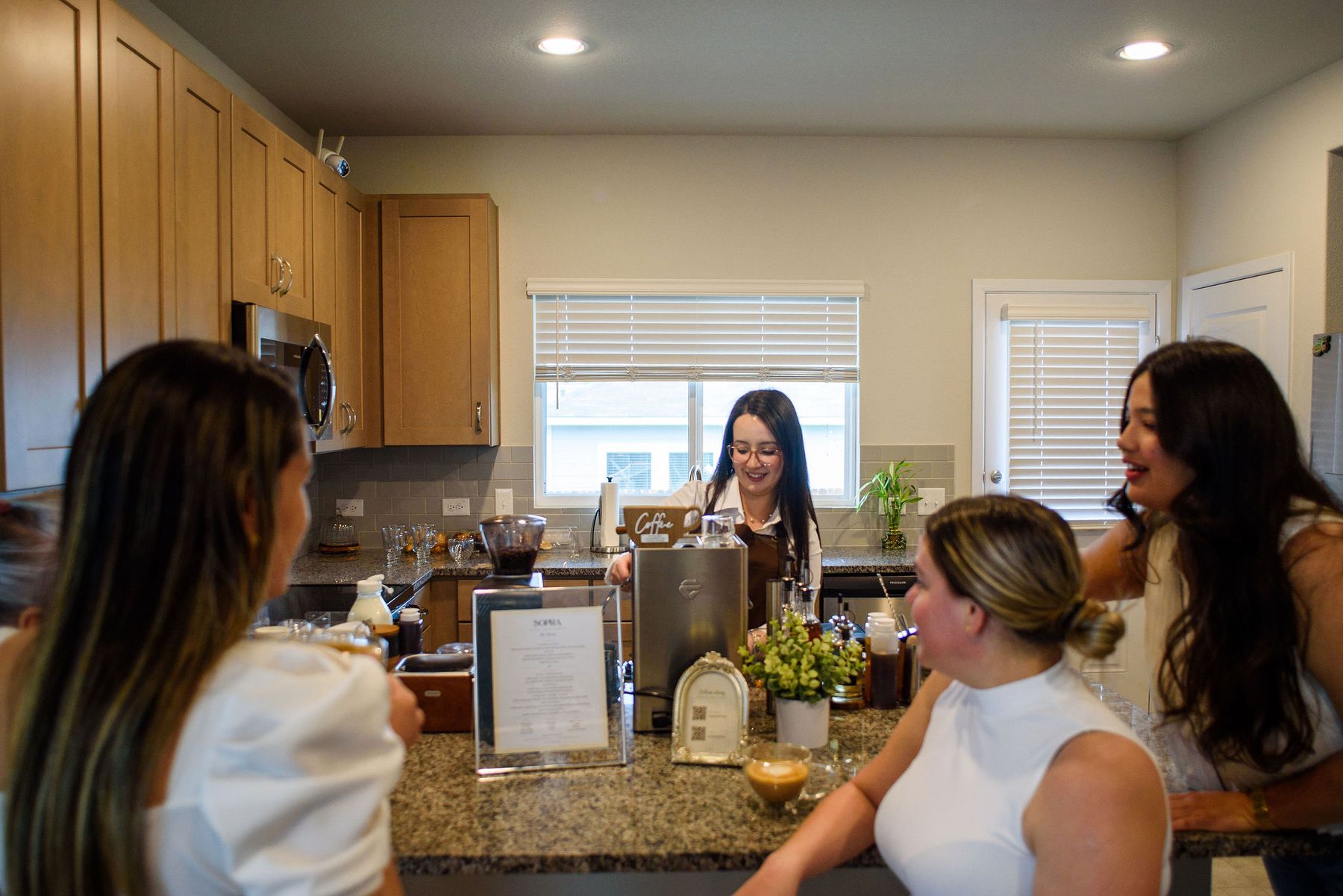 A SOPRA barista preparing coffee for guests in a home kitchen